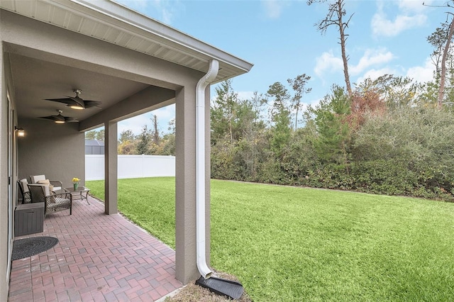 view of yard featuring ceiling fan and a patio area