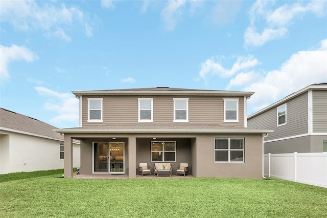 rear view of house with an outdoor living space, a patio area, and a lawn