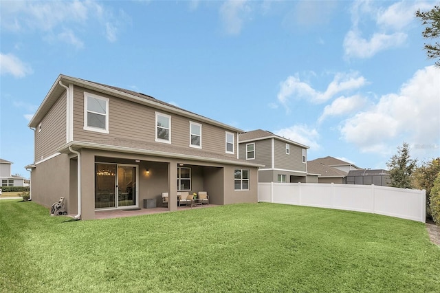 back of property featuring a patio and a lawn