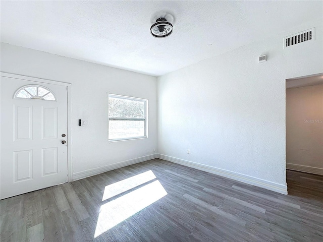 entrance foyer featuring dark wood-type flooring and a textured ceiling