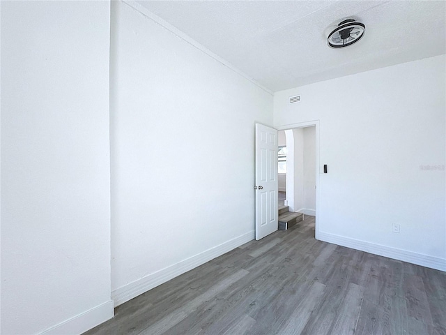 empty room featuring dark wood-type flooring