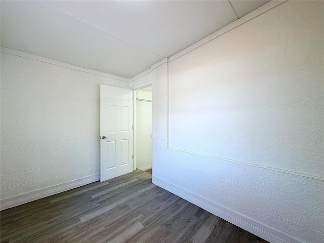 unfurnished room featuring dark hardwood / wood-style flooring