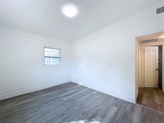 empty room with dark hardwood / wood-style flooring