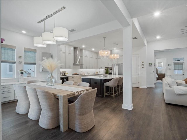 dining room with sink and dark hardwood / wood-style floors