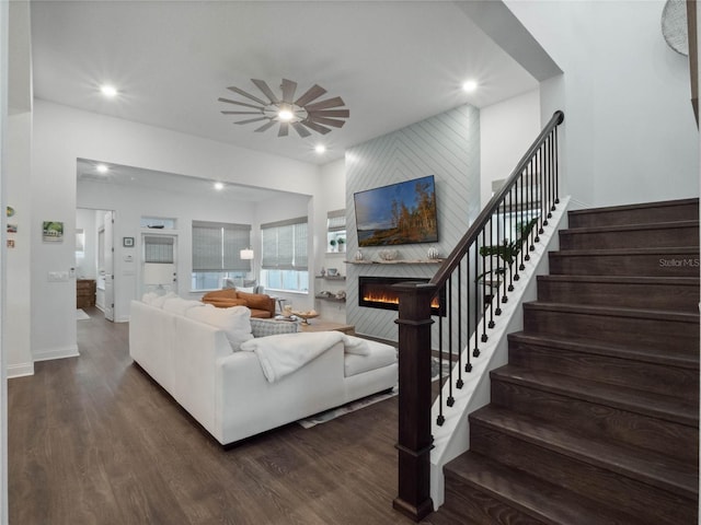 living room with ceiling fan, a fireplace, and dark hardwood / wood-style flooring