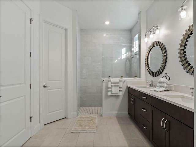 bathroom with vanity, tile patterned floors, and tiled shower