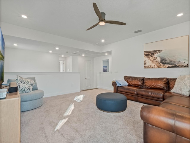 carpeted living room with ceiling fan