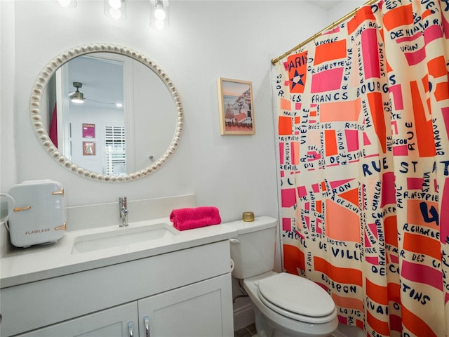 bathroom featuring a shower with curtain, vanity, ceiling fan, and toilet