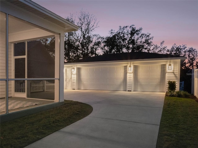 view of garage at dusk