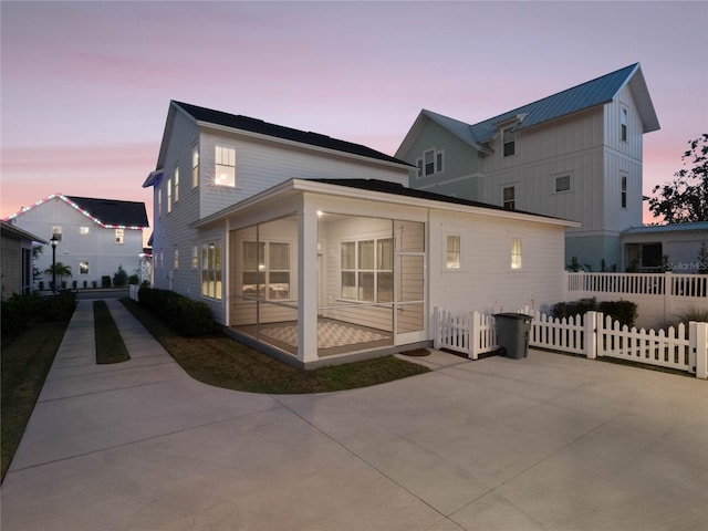 property exterior at dusk with a patio