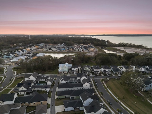 aerial view at dusk with a water view