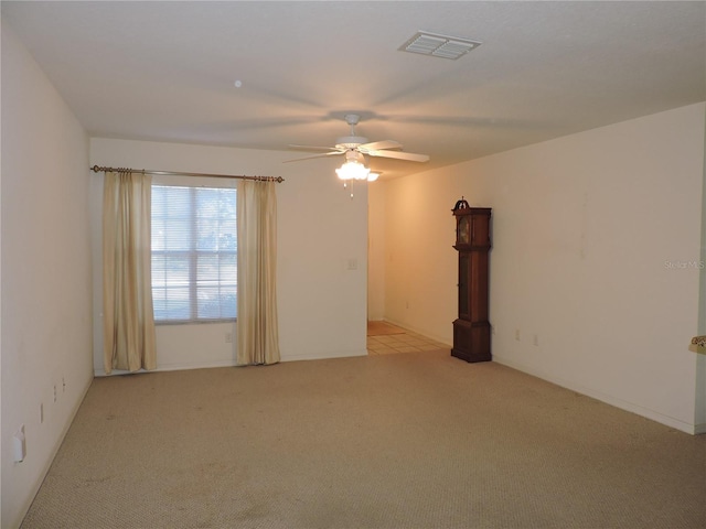 empty room with light carpet and ceiling fan