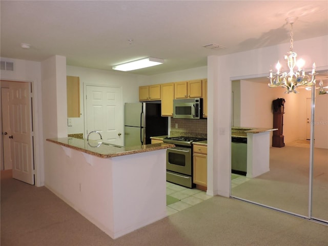 kitchen with pendant lighting, a breakfast bar area, stainless steel appliances, decorative backsplash, and kitchen peninsula