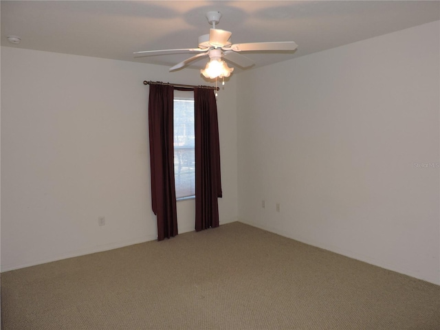 empty room with ceiling fan and carpet flooring