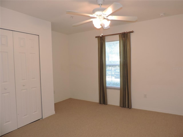 unfurnished bedroom with a closet, ceiling fan, and carpet