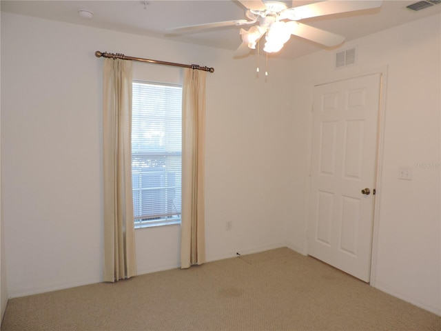 empty room featuring light colored carpet and ceiling fan