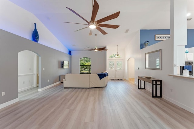 living room with light hardwood / wood-style flooring, high vaulted ceiling, and ceiling fan