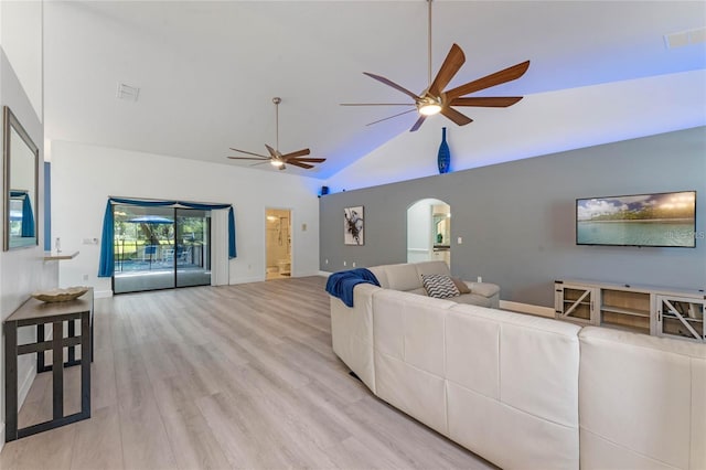 living room with ceiling fan, vaulted ceiling, and light hardwood / wood-style flooring