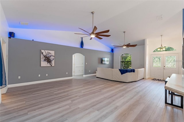 unfurnished living room featuring lofted ceiling, light hardwood / wood-style floors, and ceiling fan