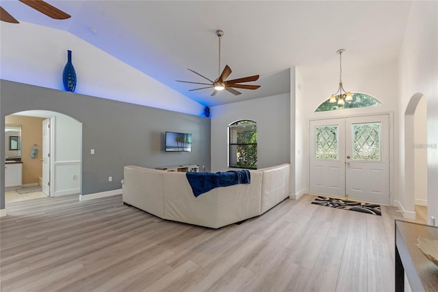 living room featuring high vaulted ceiling, hardwood / wood-style floors, ceiling fan, and french doors