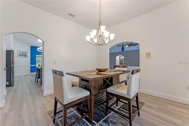 dining room featuring crown molding, ceiling fan, and light hardwood / wood-style floors