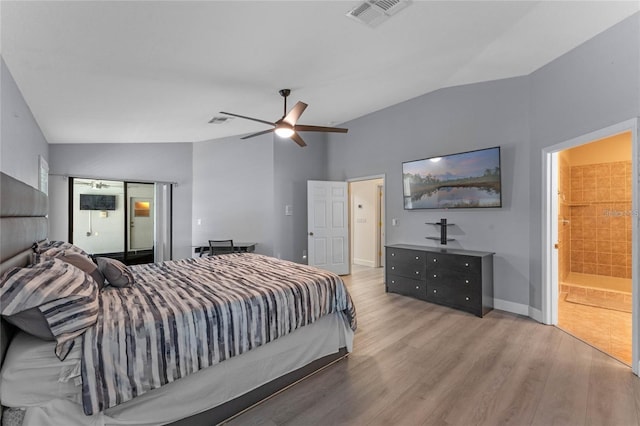 bedroom with lofted ceiling, ensuite bath, light hardwood / wood-style floors, and ceiling fan