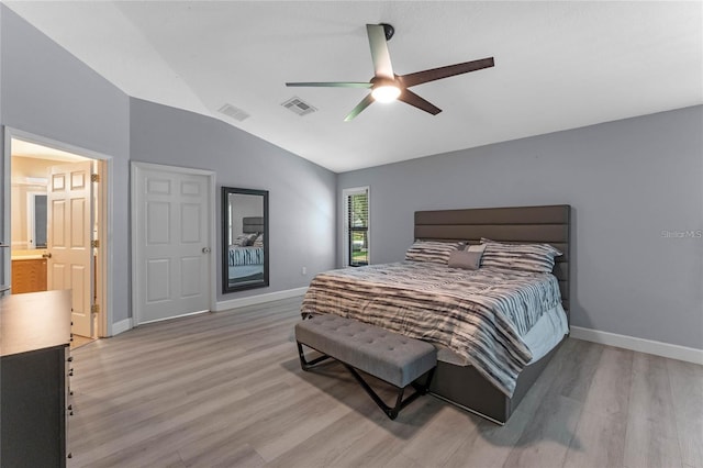 bedroom featuring vaulted ceiling, connected bathroom, ceiling fan, and light hardwood / wood-style floors