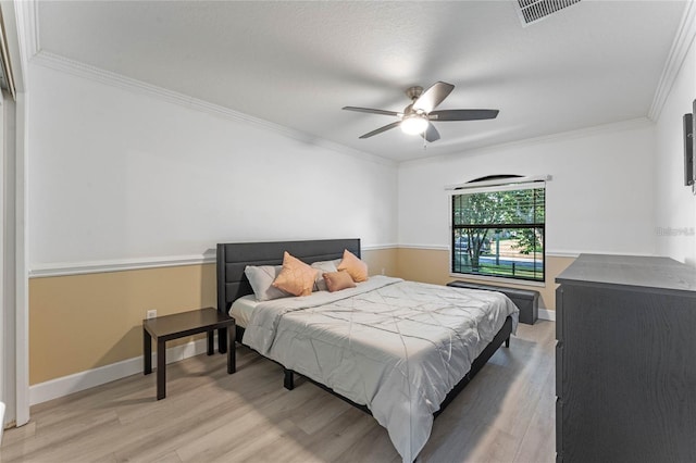 bedroom with crown molding, ceiling fan, and hardwood / wood-style flooring