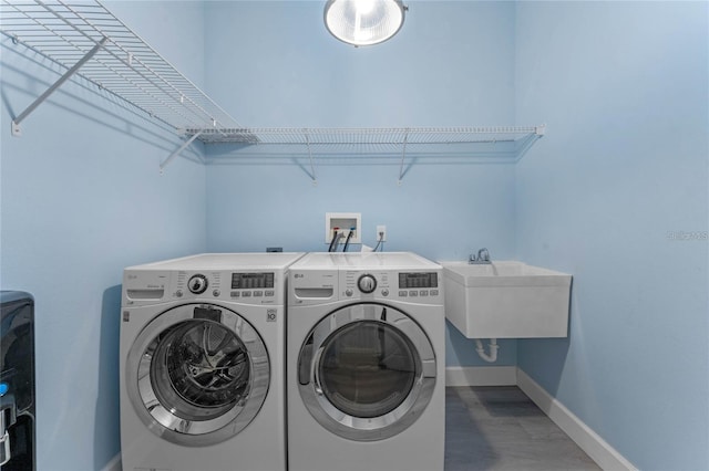 laundry room featuring washing machine and clothes dryer and sink