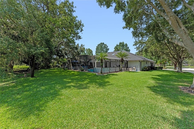 view of yard featuring glass enclosure