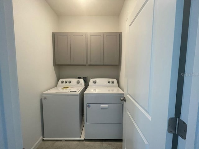 laundry area with cabinets and separate washer and dryer