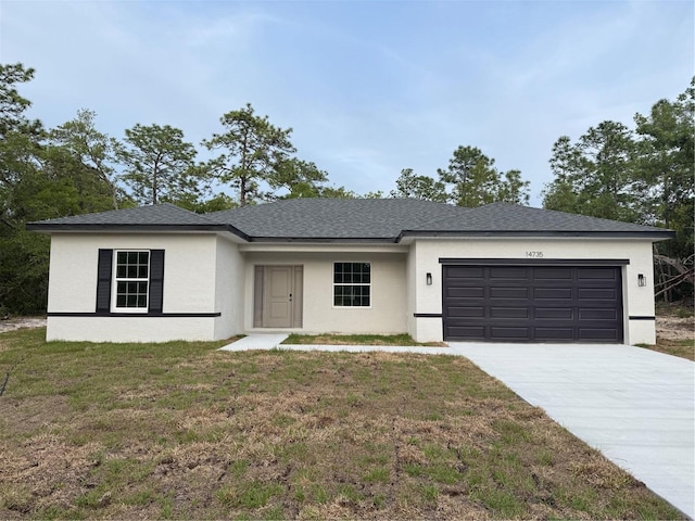 14735 SW 69th Court Rd, Ocala, FL 34473 - view of front of property featuring an attached garage, concrete driveway, stucco siding, and a front yard