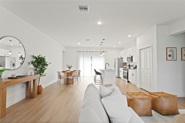 14735 SW 69th Court Rd, Ocala, FL 34473 - living area with light wood-style floors, recessed lighting, and baseboards