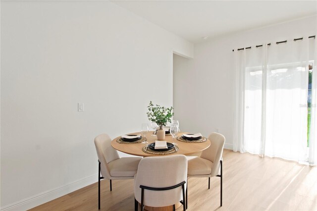 14735 SW 69th Court Rd, Ocala, FL 34473 - dining room featuring light wood-style floors and baseboards