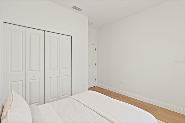 14735 SW 69th Court Rd, Ocala, FL 34473 - bedroom with light wood finished floors, baseboards, and a closet