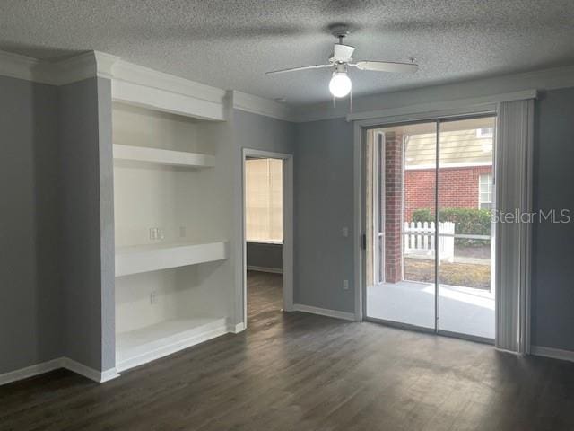 empty room with ceiling fan, dark hardwood / wood-style floors, crown molding, and a textured ceiling