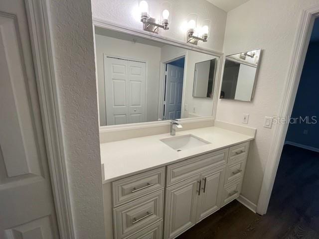 bathroom with hardwood / wood-style flooring and vanity