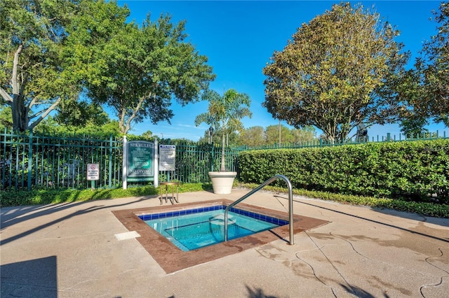 view of swimming pool with a community hot tub