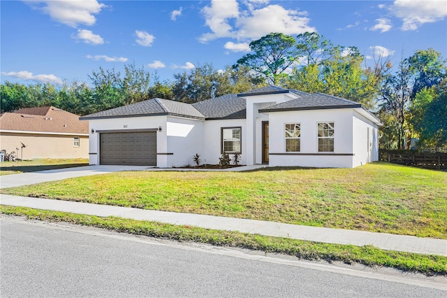 view of front of house with a garage and a front lawn