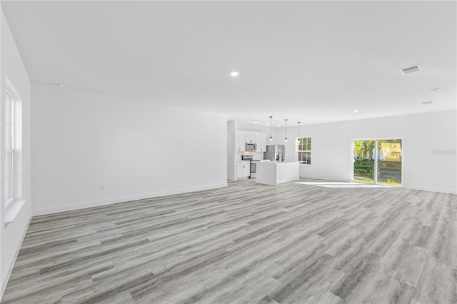 unfurnished living room with light hardwood / wood-style floors