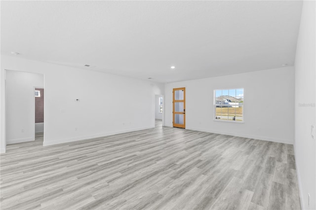 unfurnished living room with light wood-type flooring