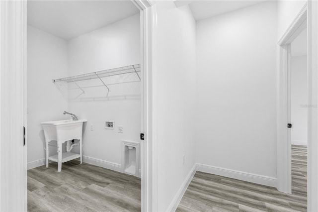 laundry area with hookup for a washing machine and light hardwood / wood-style floors