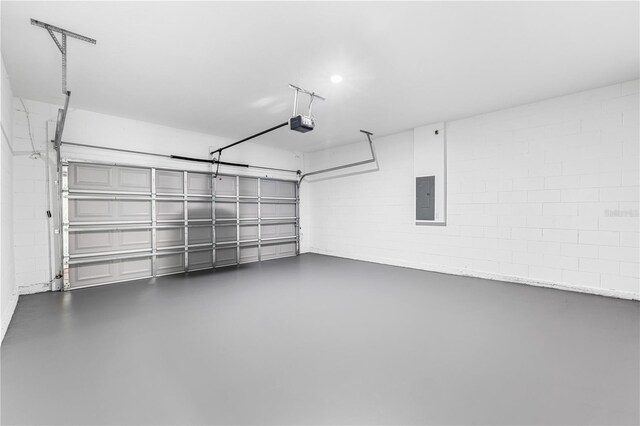 garage featuring a garage door opener and electric panel