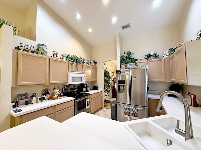 kitchen featuring appliances with stainless steel finishes, sink, and light brown cabinets