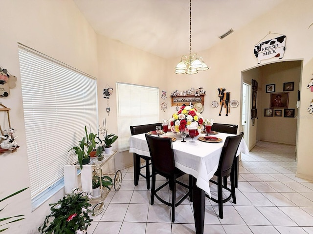 tiled dining space with a chandelier