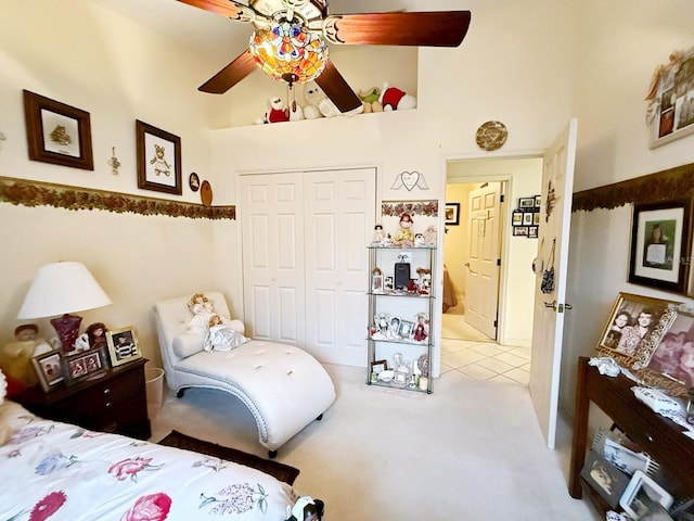 bedroom featuring a closet, ceiling fan, and a high ceiling