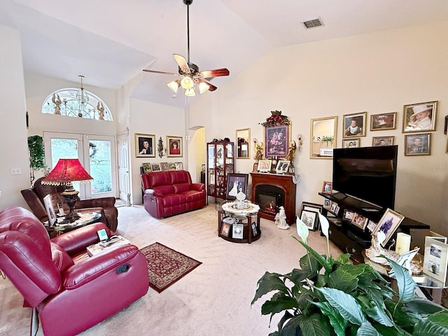 carpeted living room with french doors, ceiling fan, and high vaulted ceiling