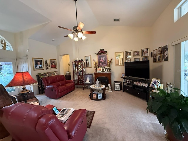 living room with high vaulted ceiling, carpet floors, and ceiling fan