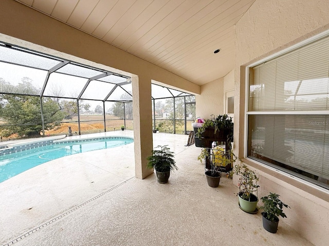 view of pool featuring a patio and a lanai