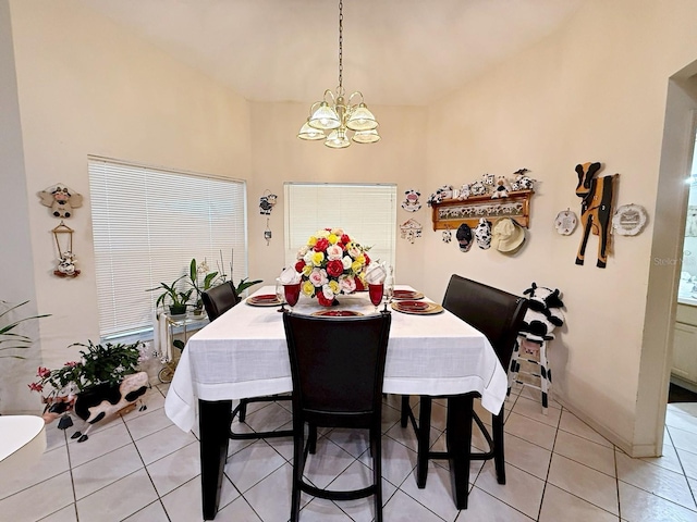 dining space featuring an inviting chandelier and light tile patterned floors